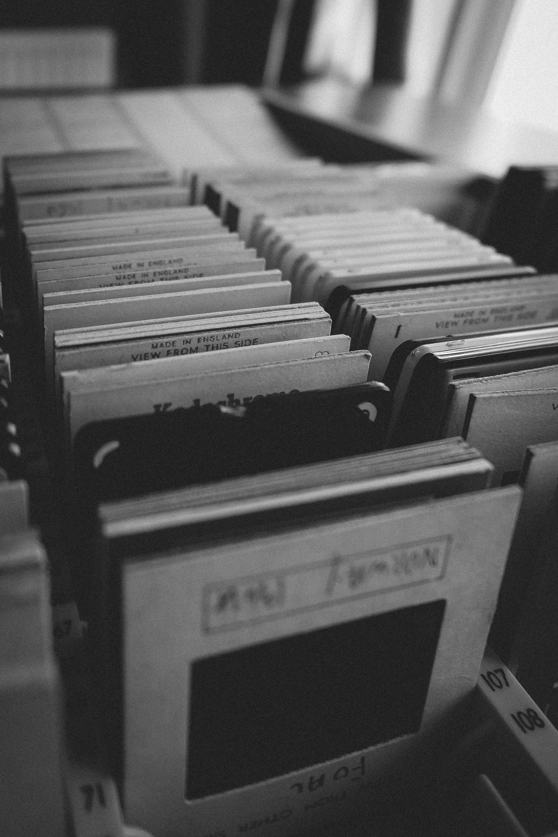 Rows of catalogued photographic slides filed upright in a drawer